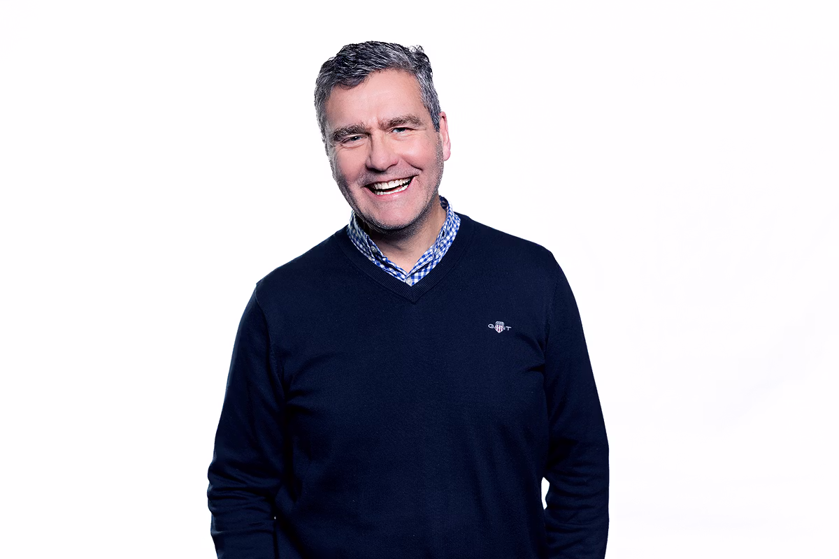 Corporate headshot photographer capturing a confident executive portrait with natural lighting