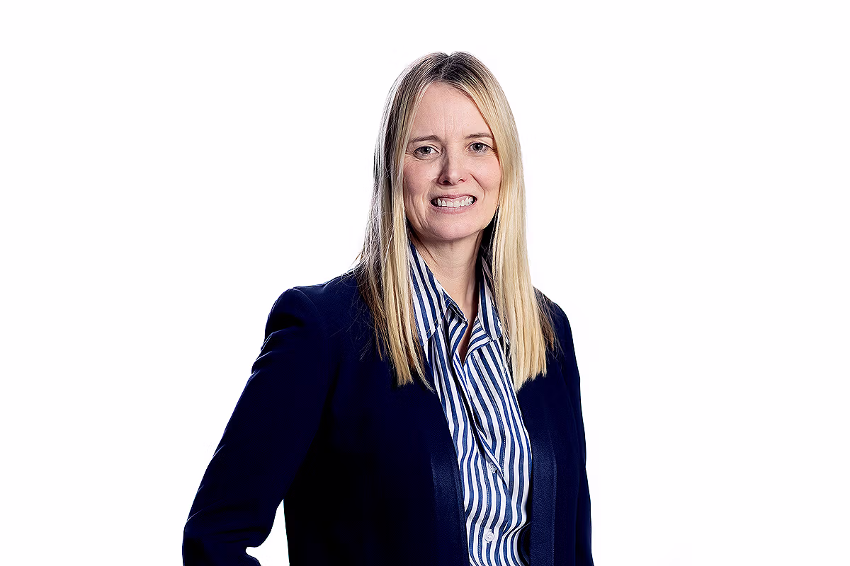 Corporate headshot photographer delivering a leadership team portrait with natural expression