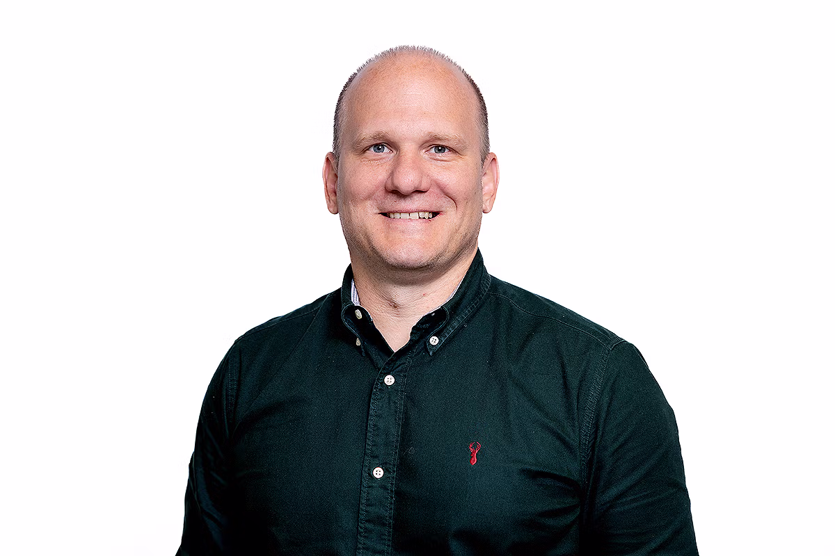 Corporate headshot photographer capturing a professional business portrait on a white background